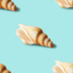 Seamless colorful pattern of shells on pastel blue color background. From top view. Conceptual trendy style. Minimal background