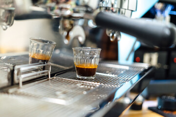 Close of the espresso machine. Professional coffee making.crystal glass seen from the side