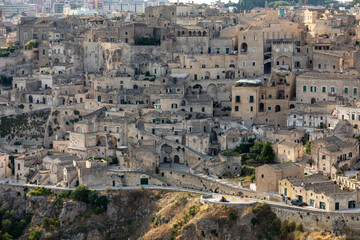 Panoramic view of Sassi di Matera a historic district in the city of Matera, well-known for their ancient cave dwellings from the Belvedere di Murgia Timone,  Basilicata, Italy