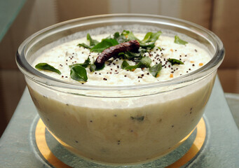 curd rice well garnished with curry leaves andred chilli