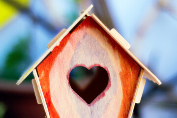 Wooden diy birdhouse, heart-shaped window, ble background