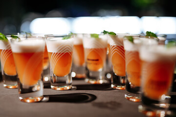 Assortment of alcoholic shot-drinks with mint leaves