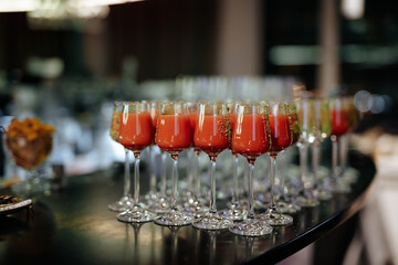 Set of alcoholic cocktails in glasses served on bar counter