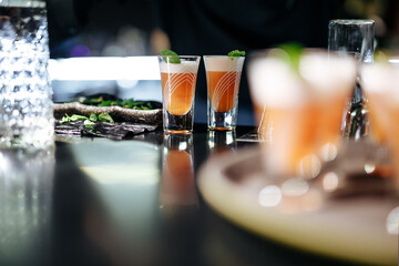 Colorful alcoholic cocktail shot-drinks with mint leaves