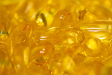 Closeup view macro photography of supplement organic vitamins in big transparent capsules. Omega 3 pills isolated on white background.