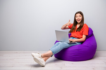 Portrait of her she nice attractive lovely cheerful cheery excited straight-haired girl sitting in...