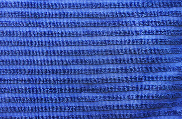 Terry cloth blue paper towel background. Bright blue lined soft terry cotton fabric towel. Structure with uncut loops of threads, bath towel cloth closeup texture