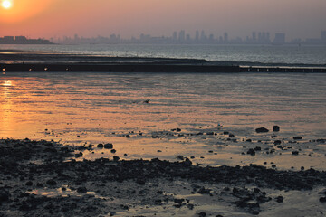 A beautiful orange reflection in the ocean water captured during sunset.