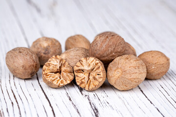 Nutmeg on the wooden background