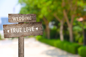 Wooden plaques with inscriptions Wedding and True Love outdoors, space for text