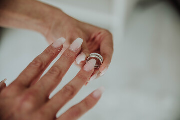 the bride wears a wedding ring on her finger