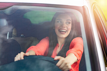 Beautiful Smiling woman driving car, attractive girl sitting in automobile, outdoors summer...
