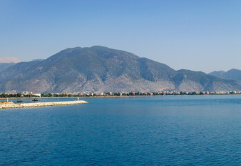 Fototapeta na wymiar High mountain with greenery by the Mediterranean Sea