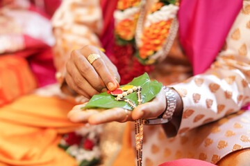 Indian groom doing jewelry puja during wedding