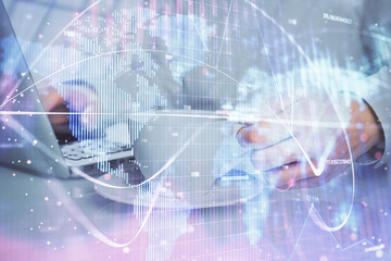 Double exposure of businessman working on laptop on background. International business hologram in front. Concept of success.