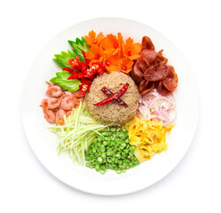 Rice seasoned with shrimp paste or rice mix slice of red onion, bean,mango, fried egg, Thai food style fusion decorate with carved vegetables top view isolated on white background