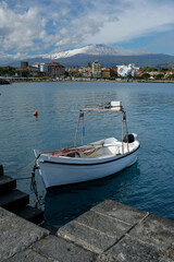 Giardini-Naxos touristic resort with beautiful Etna volcano covered with snow on Sicili, Italy