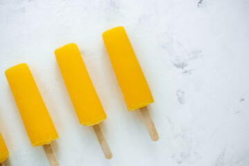 Orange fruit ice isolated on a white background. Stick ice cream