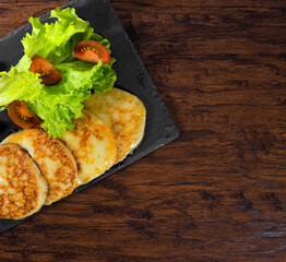 Grilled cheese with vegetables on the plate.