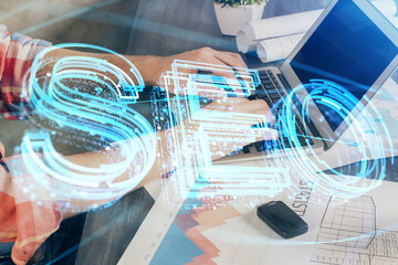 Multi exposure of seo icon with man working on computer on background. Concept of search engine optimization.