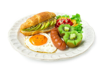 Breakfast set with croissant inside avocado salad black pepper