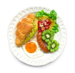 Breakfast set with croissant inside avocado salad black pepper