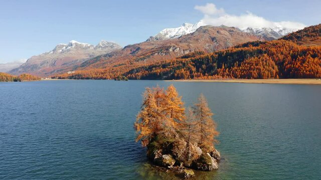 4k drone forward video (Ultra High Definition). Bright morning view of Sils Lake (Silsersee). Wonderful autumn scene of Swiss Alps, Maloja Region, Upper Engadine, Switzerpand, Europe. 