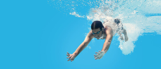 Man swimming in the blue clean water. Background with copy space. Under water training and social...