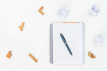 Puzzle, pencil, notebook and crumpled paper