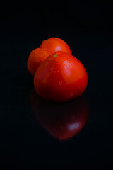 sweet fresh romanian tomatoes isolated on black background