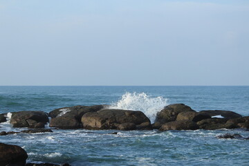 Fototapeta na wymiar Beautiful Sea Waves hitting rocks at Kanyakumari 