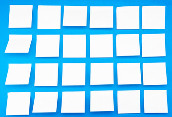 A lot of blank yellow stickers on a blue background. Side view
