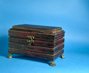 closed wooden chest on blue background
