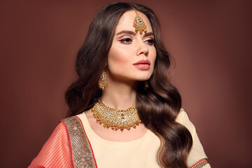 Portrait of beautiful indian girl in saree. Young hindu woman model with kundan golden jewelry set. Traditional Indian costume lehenga choli. - 356649579