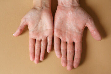 Fototapeta premium Male and female hands on a brown background close-up. Strong friendship concept