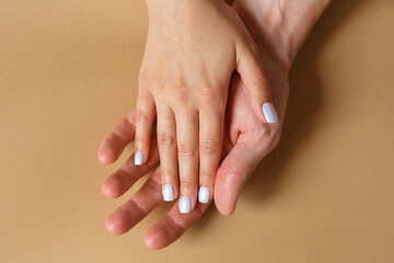 Male and female hands on a brown background close-up. The concept of love, family and fidelity. Feelings and Attitudes