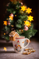 Christmas or New Year composition, a warming drink in a mug, gingerbread cookies and Christmas decorations. Festive table, winter holidays. The atmosphere of the holiday and home comfort.