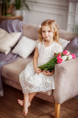 baby girl with tulips in a photo Studio, beautiful interior, spring, March