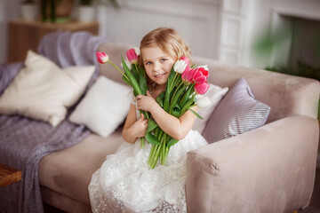 baby girl with tulips in a photo Studio, beautiful interior, spring, March
