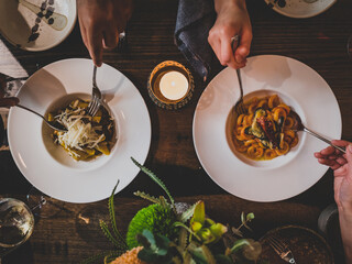 People sharing a modern Italian meal at a fine dining restaurant.