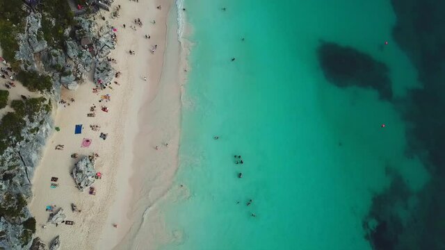 Top view of beautiful beach. Luxury tropical resort with white sand and turquoise sea water. Aerial view
