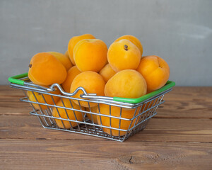 Fresh fruits. Basket with apricots on a wooden table