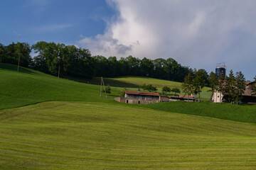 Obraz premium houses on the slopes of green hills in Switzerland