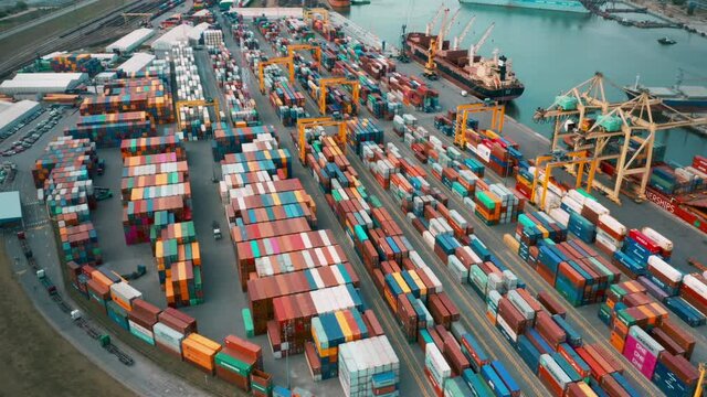 Cargo containers in busy port, aerial hyperlapse. Shipping harbor, logistics