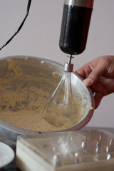Fototapeta premium Beating cream. Making butter cream filling. Making torte cupcakes with buttercream filling. Motion view.