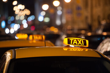 Taxi sign on the roof of a taxi at night