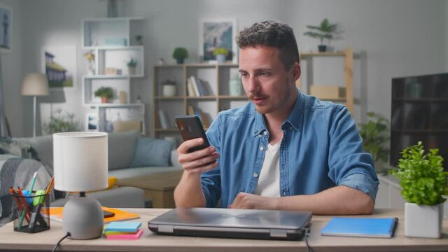 Excited guy winner hold smartphone feel amazed overjoyed with mobile online bet bid app game win