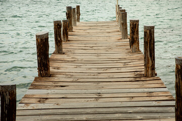 Obraz premium Pontile in legno su riva del mare con sfondo acqua