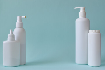 Jar with baby powder, bottle of talcum powder, liquid soap and shower gel isolated on a blue background. Body care. Spa Relax Baby hygiene.