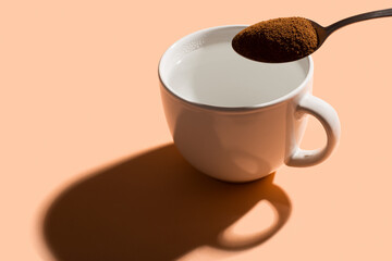 Pouring instant coffee on a cup